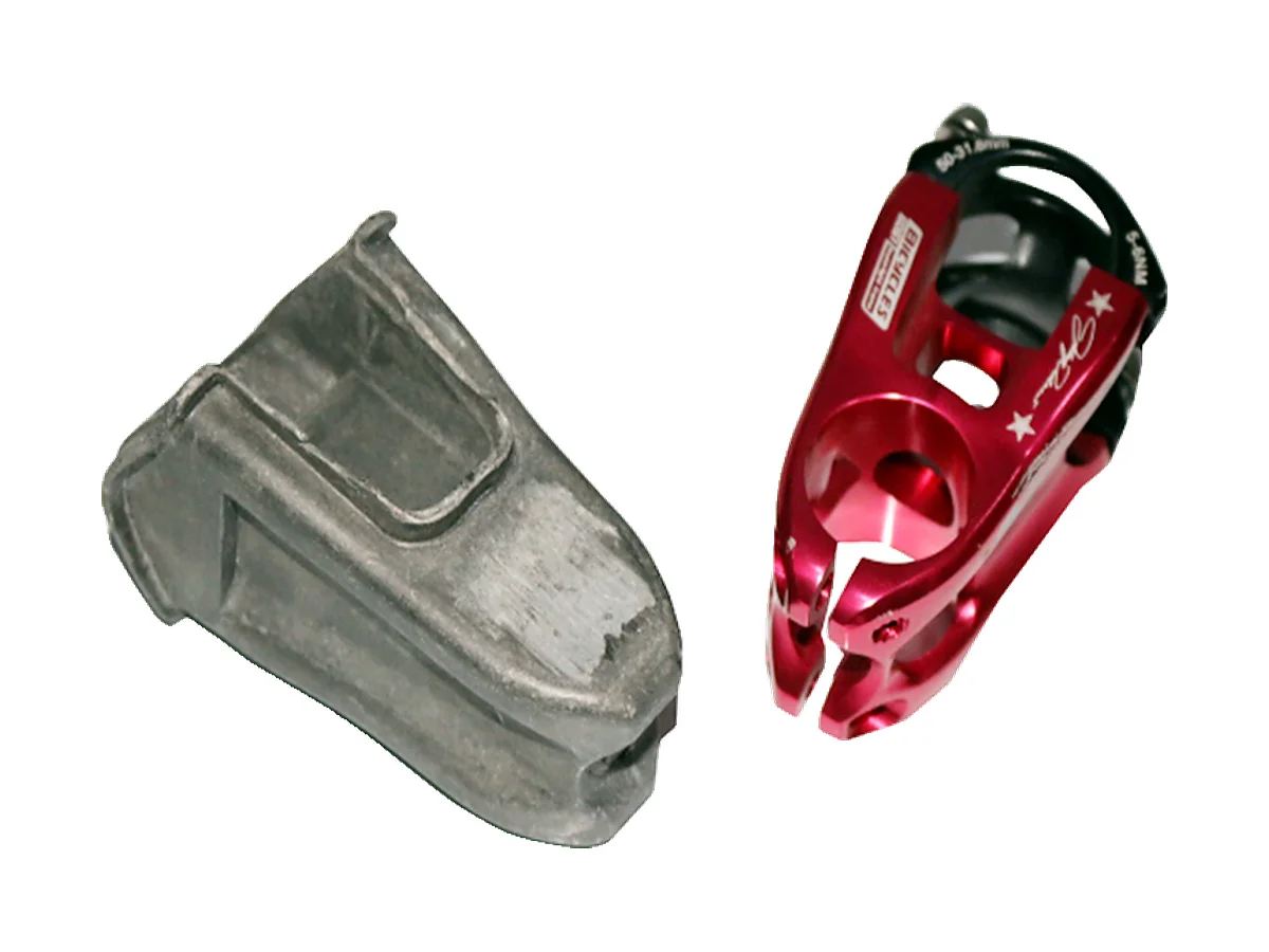 Forged aluminium stem blank next to a CNC machined anodised stem